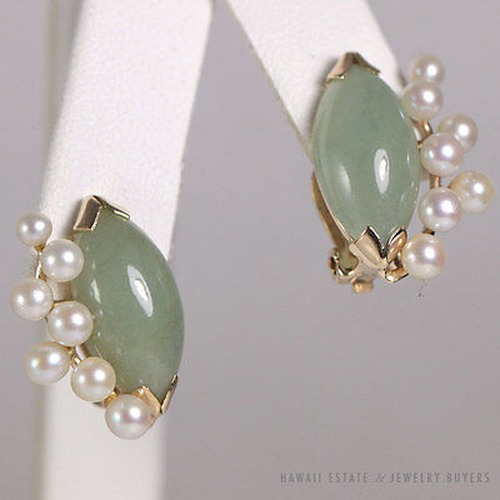 Front view of the jade and pearl earrings on a white display.