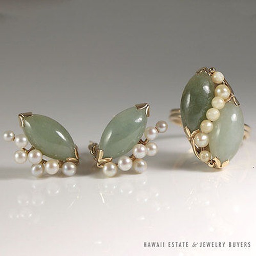 Jade and pearl ring and earring set arranged together.
