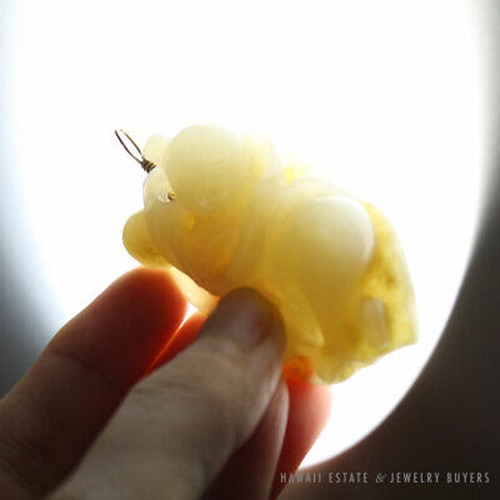 Backlit view of the carved jade pendant.