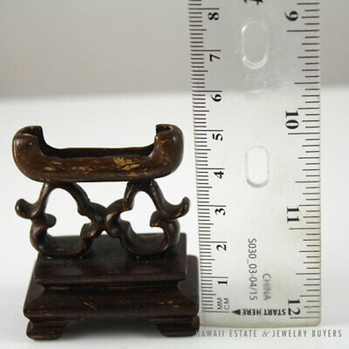 Wooden stand beside an upright ruler.