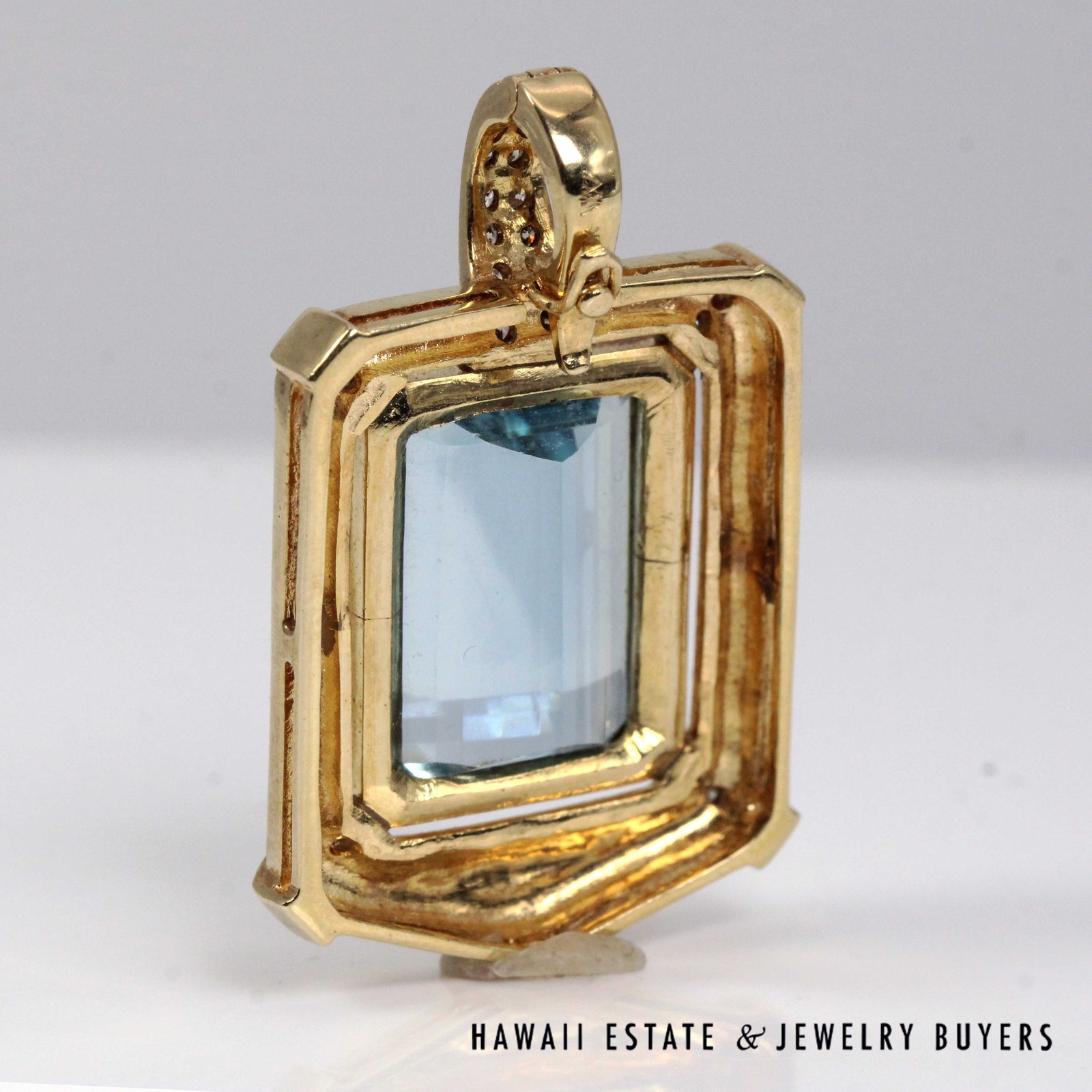 Rear view of the pendant's open-backed setting and enhancer bail.