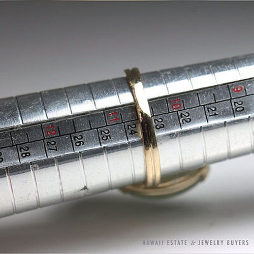 Ring from the jade and pearl set on a sizing mandrel.