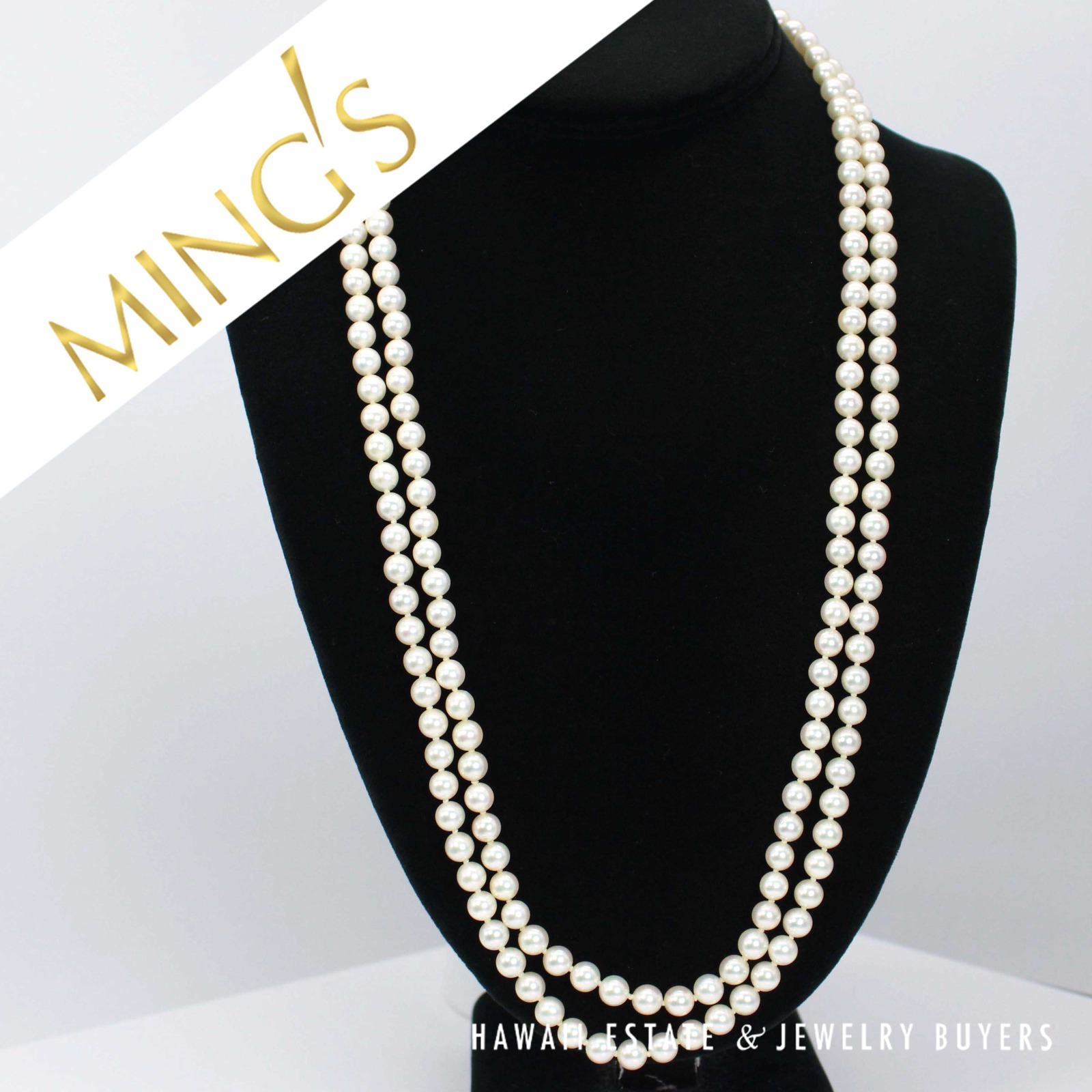 Full view of the two-strand cultured pearl necklace on a black display.
