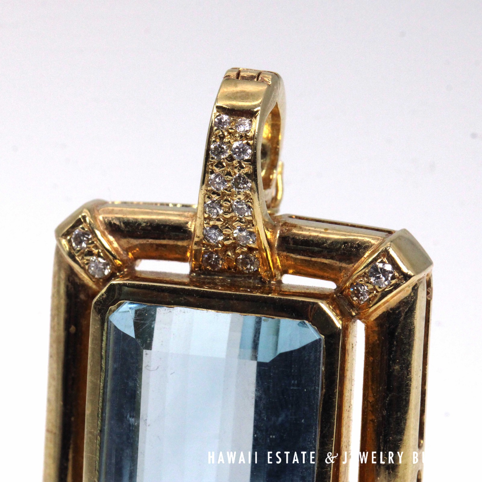 Close view of diamonds along the bail and upper corners of the pendant.