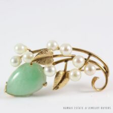 Front of the Ming's green jadeite and cultured pearl brooch with textured gold leaves.