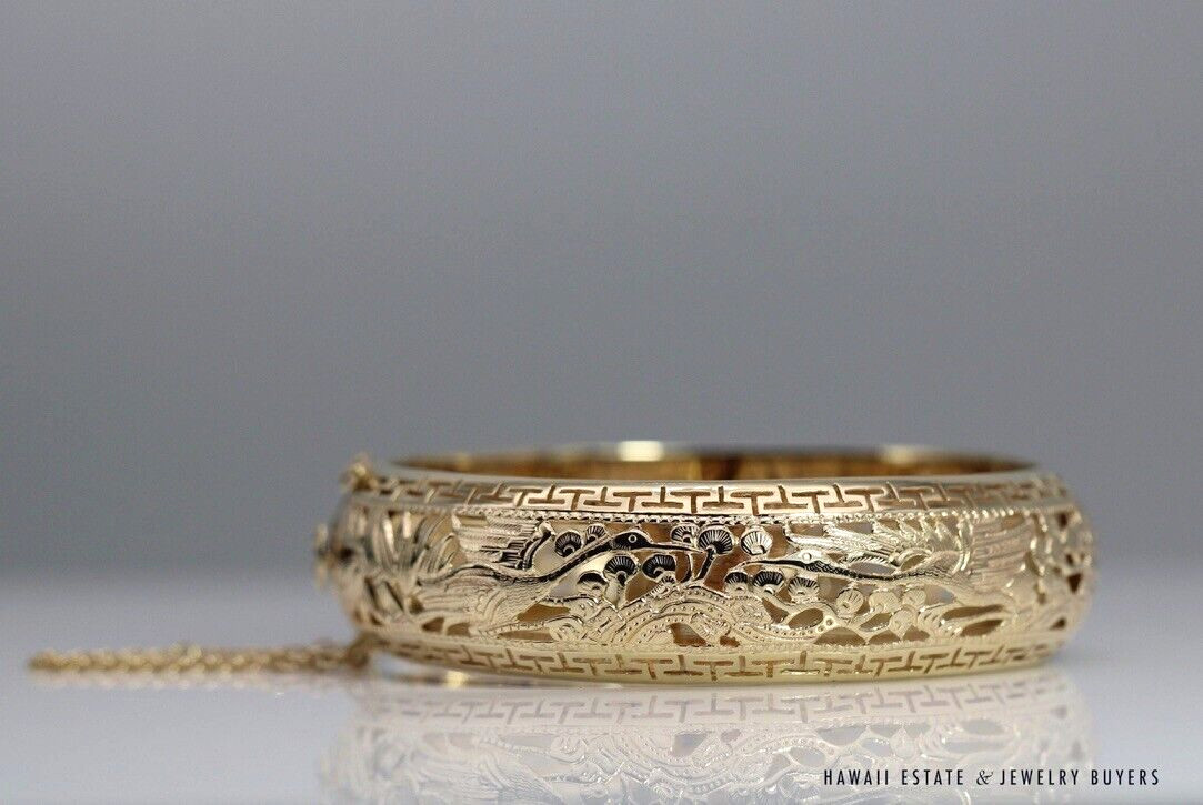 Opposite view of the Po Sun Hon bangle, showing the detailed crane design and open spaces through the gold band.