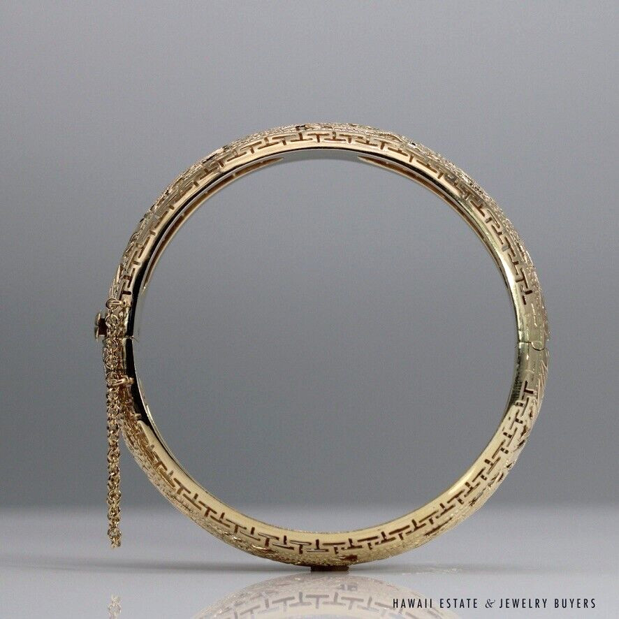 Reverse upright view of the bangle, with the safety chain at left and hinge at right.