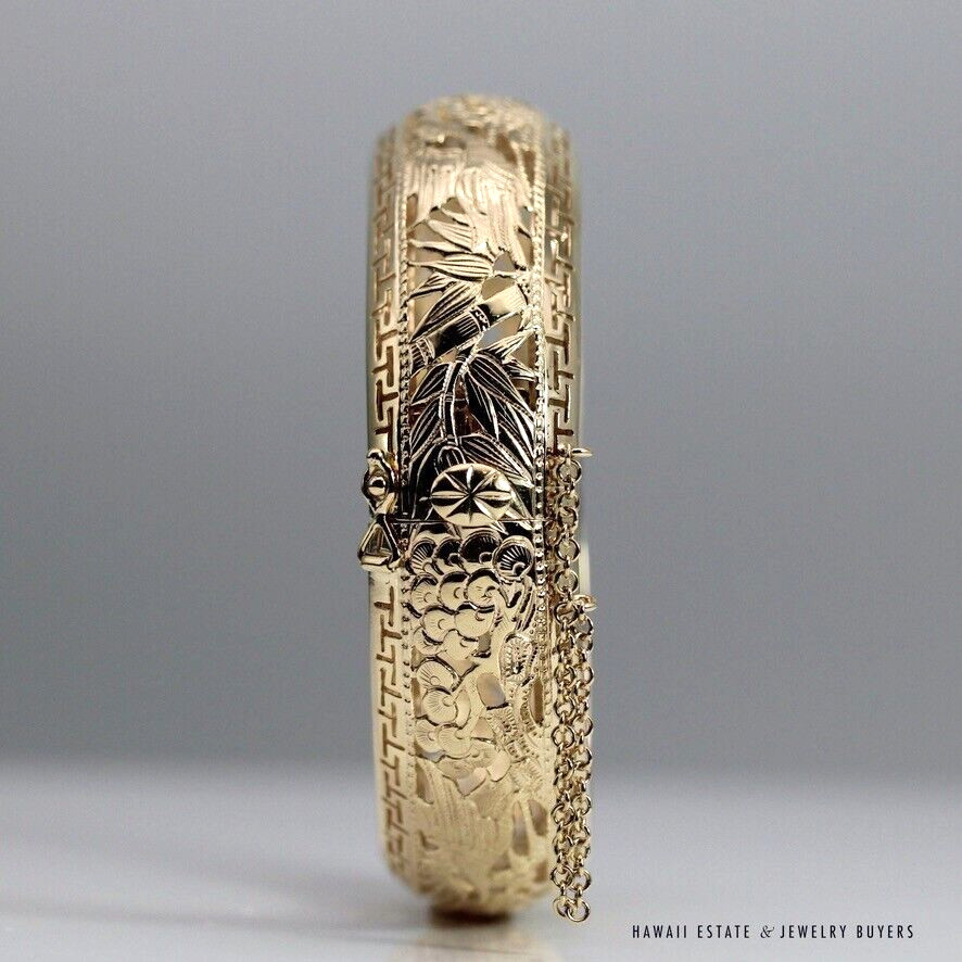 Clasp-side view of the bangle showing bamboo detail, the clasp and draped safety chain.
