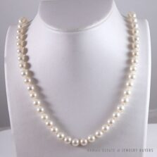 Single-strand pearl necklace displayed on a white necklace bust.