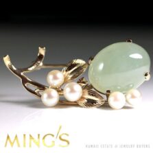 Ming's brooch with a pale green oval jade cabochon, pearl accents and veined gold leaves.