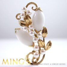 Front of the Ming's white jade and pearl brooch displayed upright.