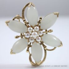 Ming's flower brooch with six light gray marquise jade petals around a pearl center.