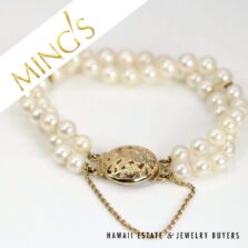 Ming's double-strand cultured pearl bracelet with a gold Bird in Plum clasp and safety chain.