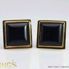 Pair of square black jade sugarloaf cufflinks in 14K yellow gold frames, shown face up.