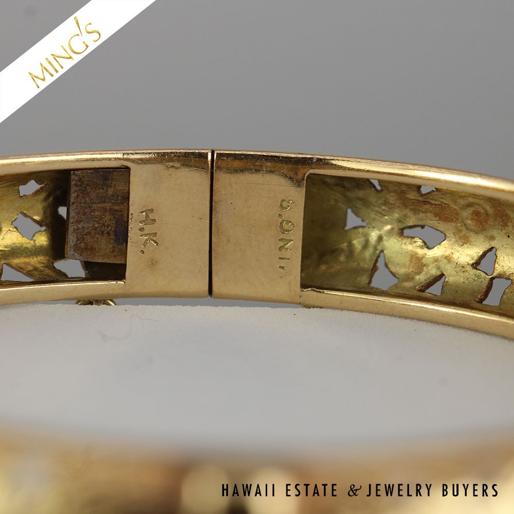 Close view inside the bangle at the clasp and stamped markings.