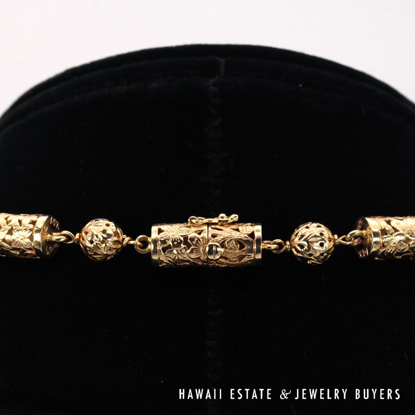 Close view of the cylindrical box clasp among the pierced beads.