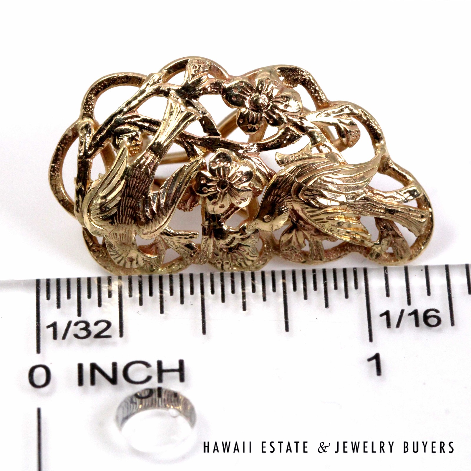Bird in Plum earring beside an inch ruler, showing its elongated openwork outline.
