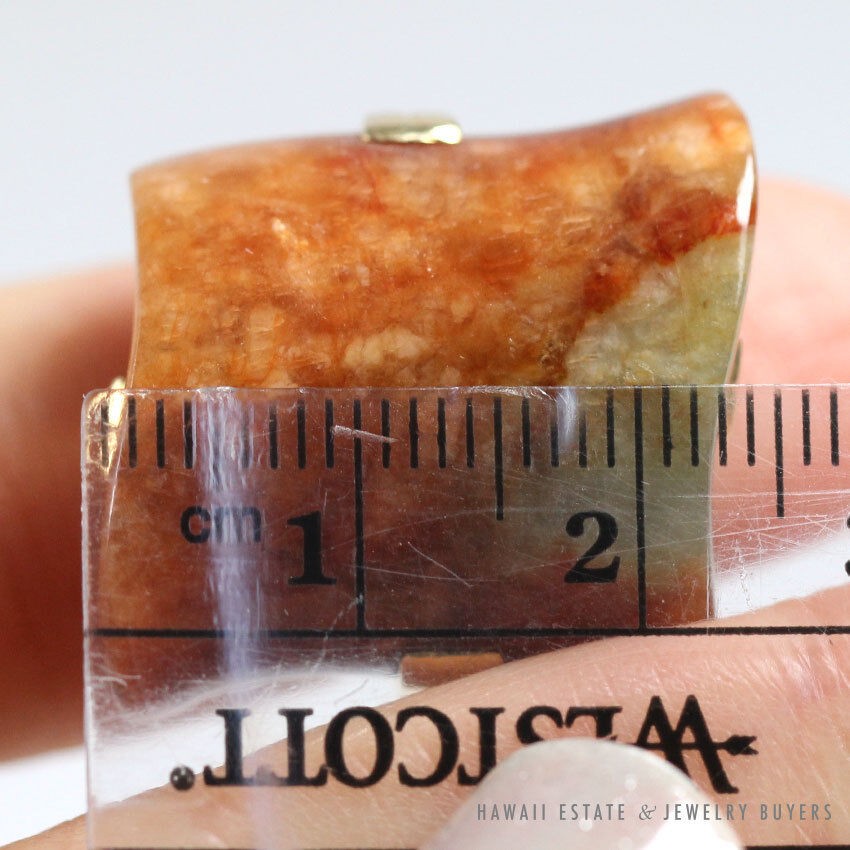 Close view of the ring stone beside a ruler.