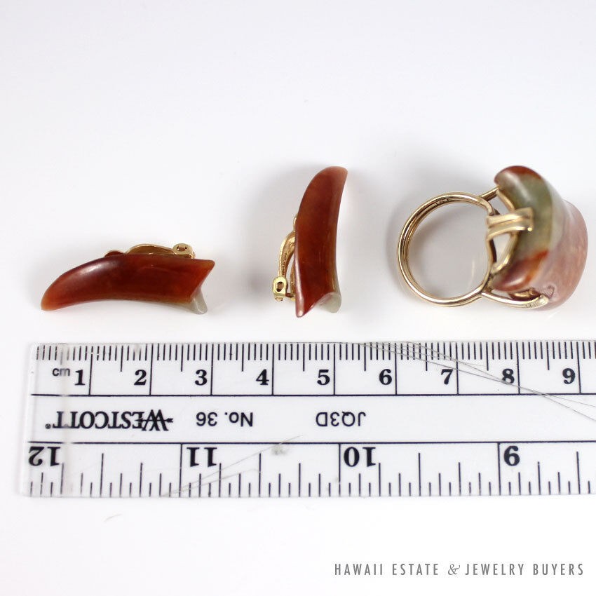 Ring and earrings arranged beside a ruler, showing their side profiles.