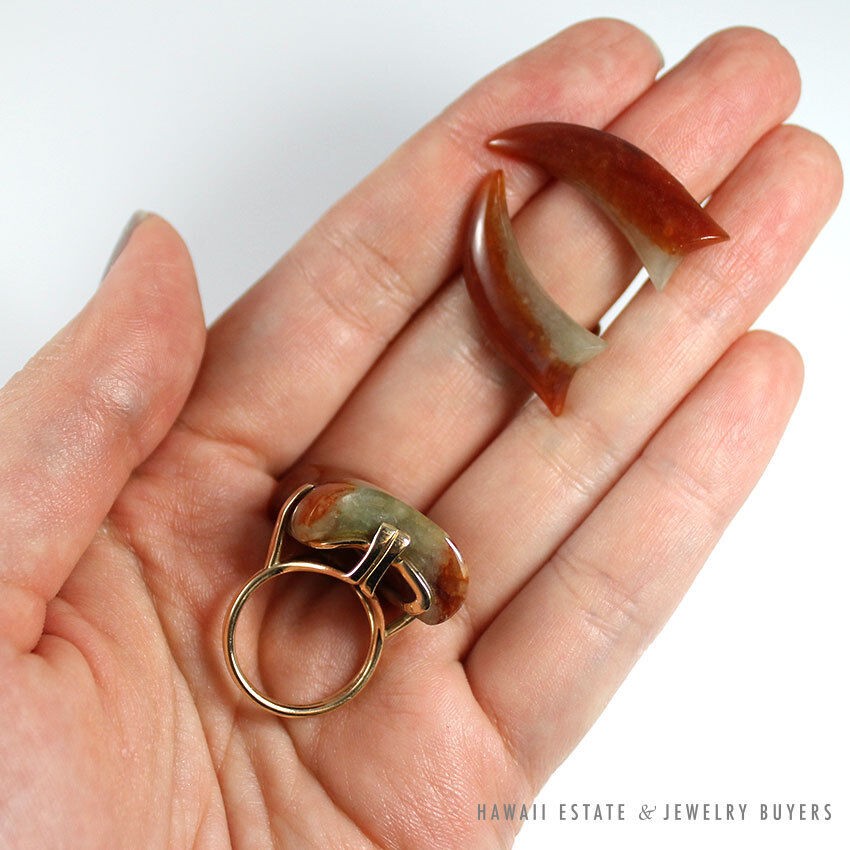 Earrings and underside of the ring shown together on a hand.