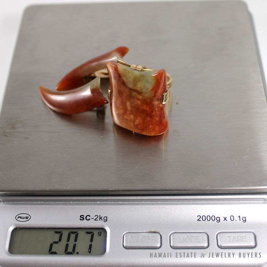 Ming's ring and earring set on a scale displaying 20.7 grams.