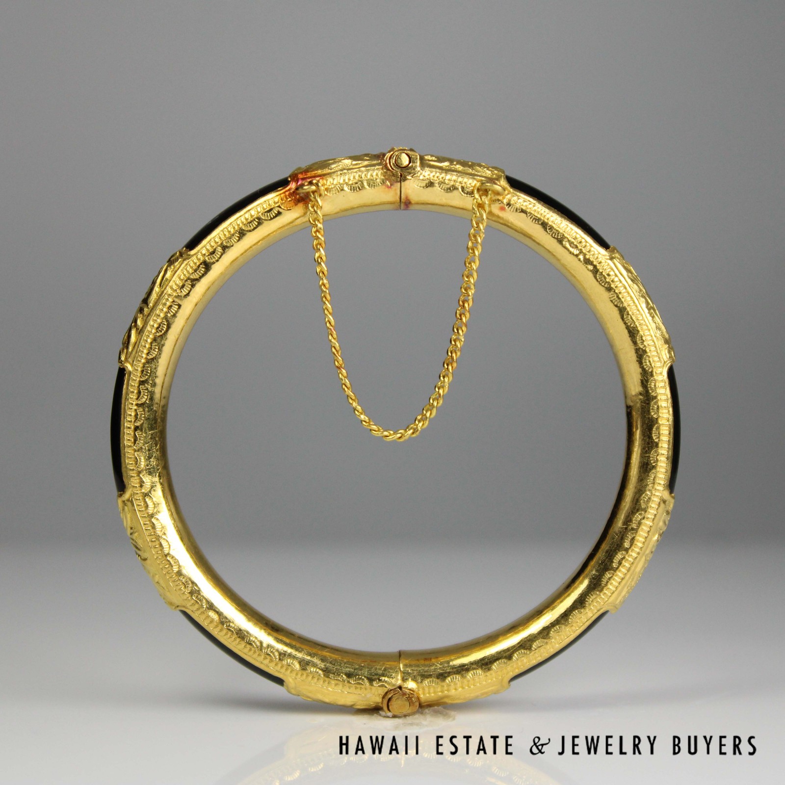 Full upright view through the bangle, showing its inner edge and hanging chain.