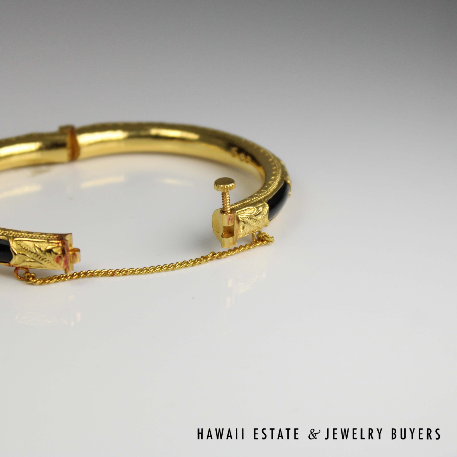 Bangle with the screw closure open and the chain stretched between the ends.